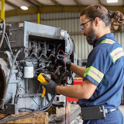 Cox employee working on a car