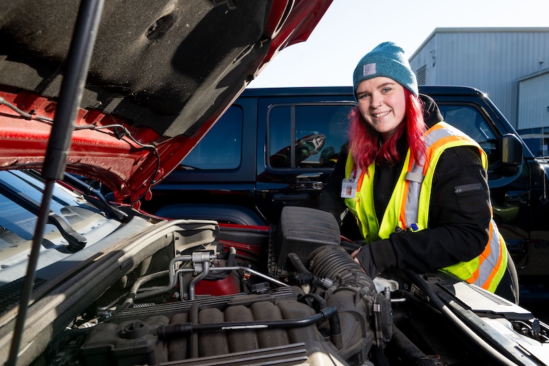 Cox Automotive technician working under the hood of a car
