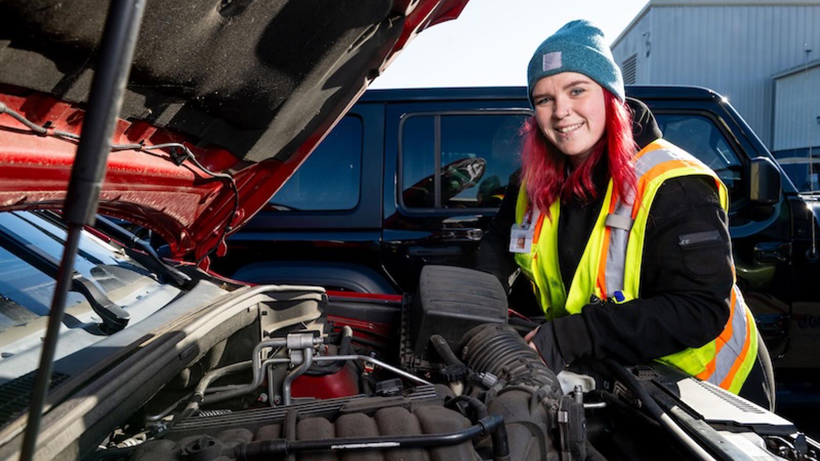 Cox Automotive technician working under the hood of a car