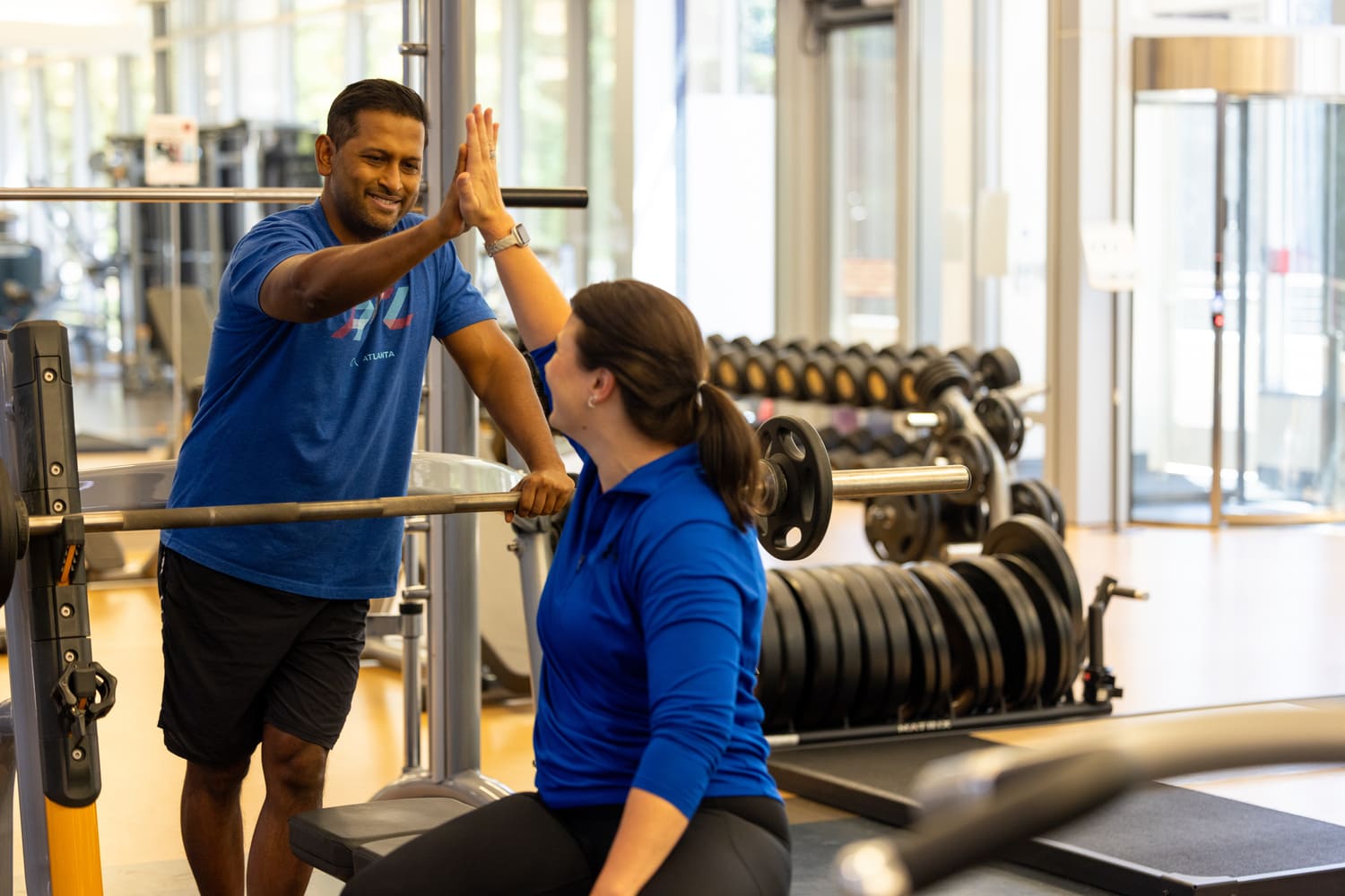 a person giving a high five to a person in a gym