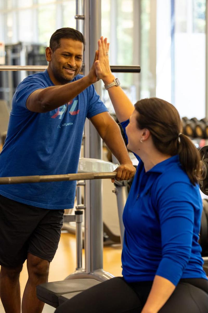 a person giving a high five to a person in a gym