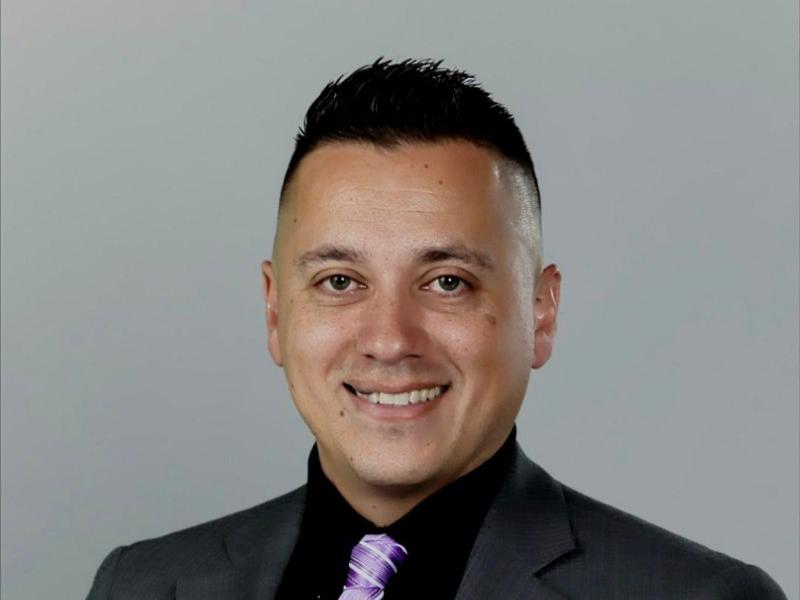 a Cox employee in a suit and tie