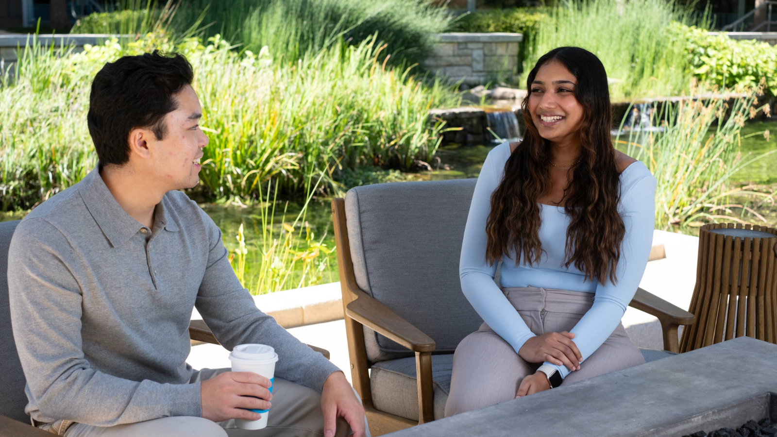 a person and person sitting on chairs and talking