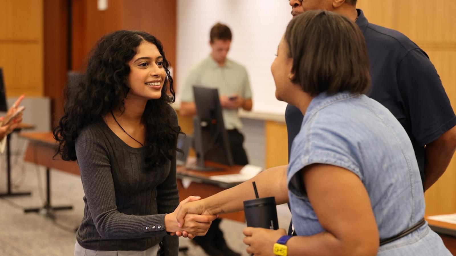 a person shaking hands with another person