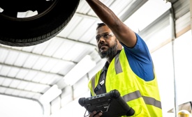 Cox auto technician fixing car