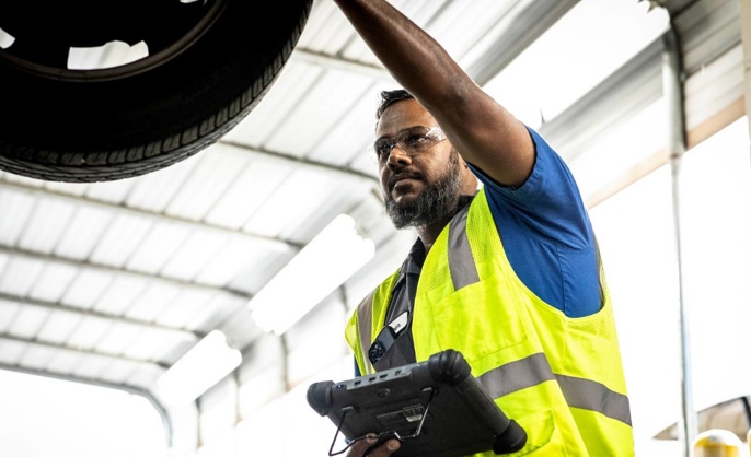 Cox auto technician fixing car