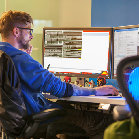 Cox employee working on computer monitor