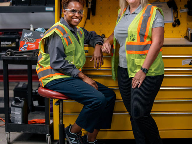 Cox Manheim employees smiling in garage