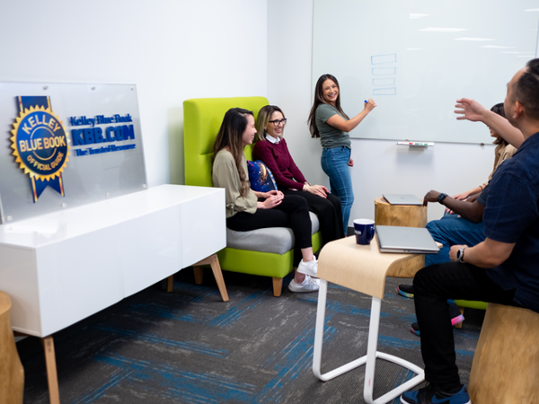 Kelly Blue Book Employees collaborating on whiteboard