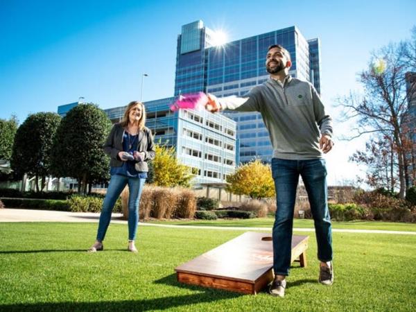 Cox employees Amit Vyas and Anne Gilk playing cornhole