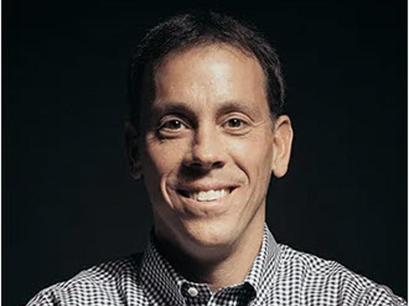 an AJC employee smiling at the camera