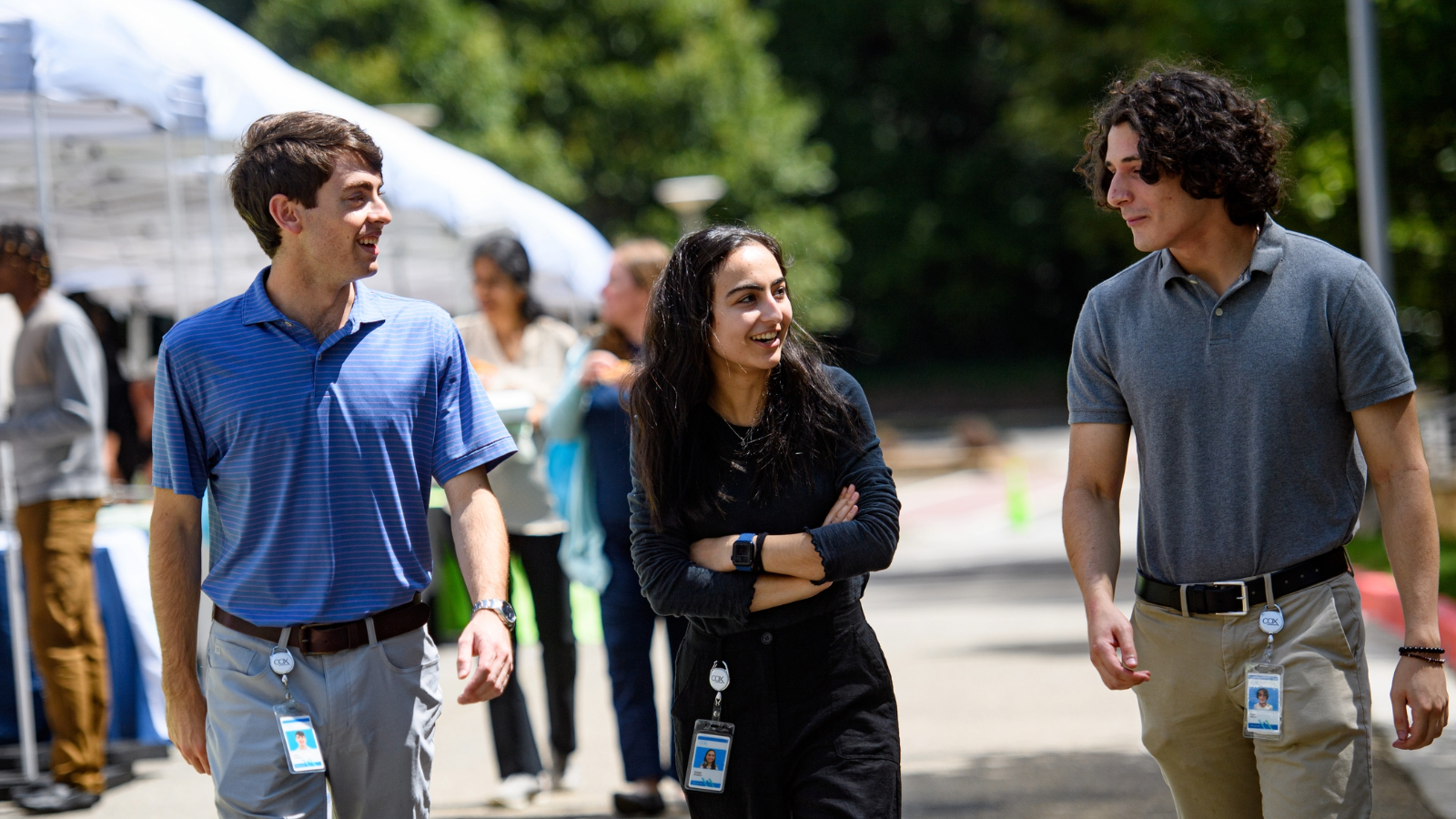 a group of people walking on a sidewalk