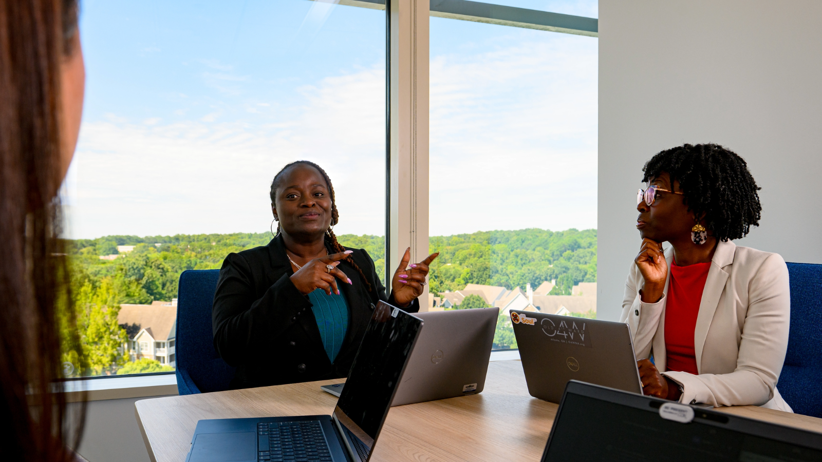 a person pointing at a laptop