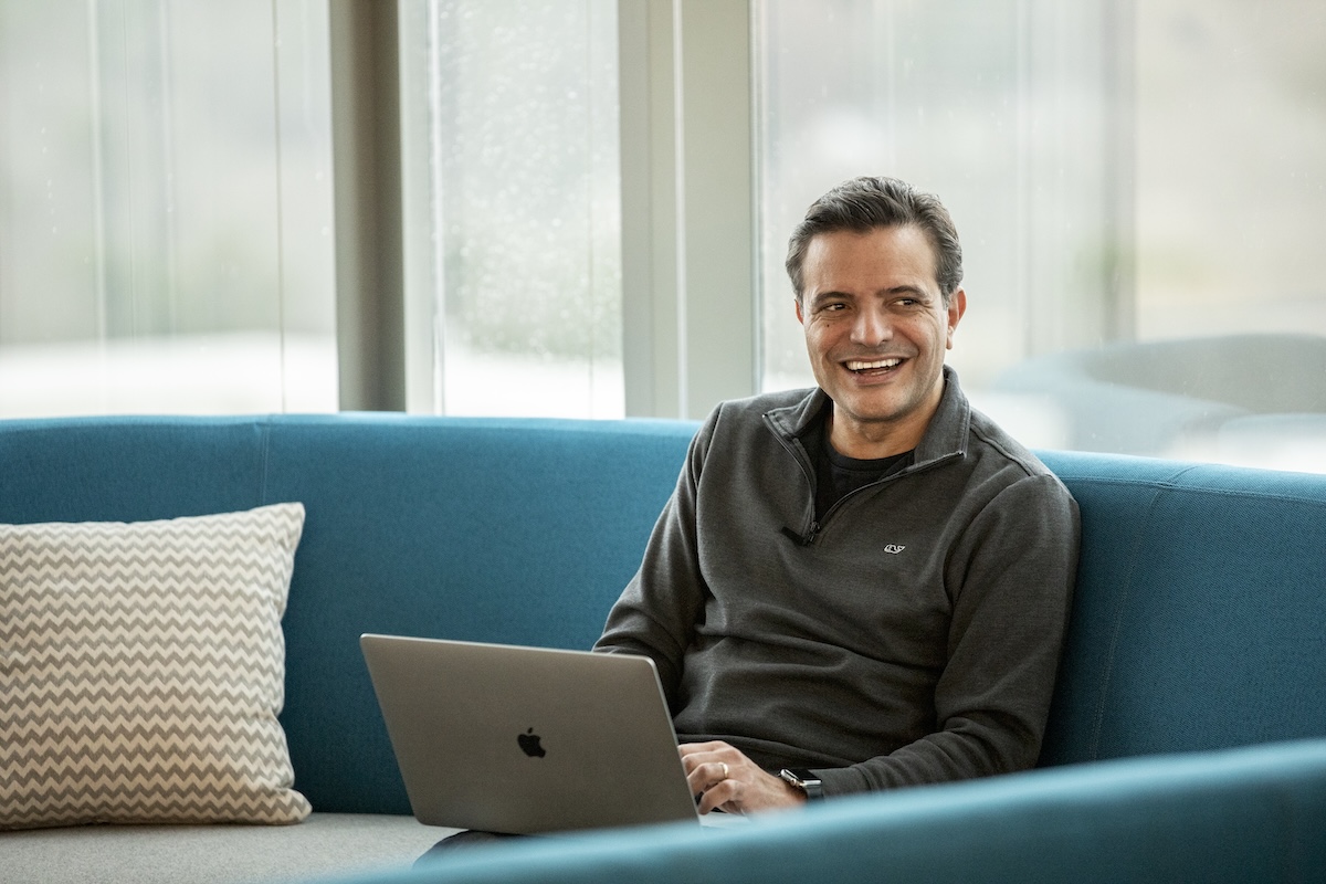 a person sitting on a couch with a laptop