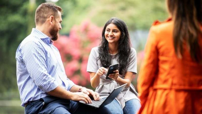 Cox employees collaborating outdoors