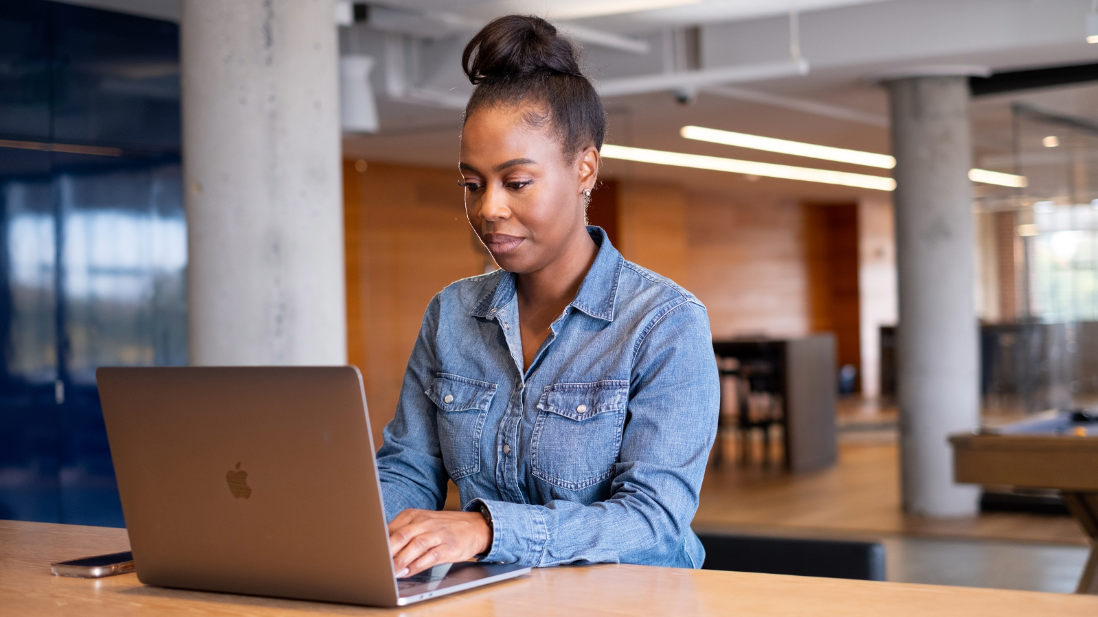 a person sitting at a desk using a laptop