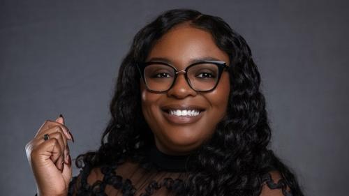 a person wearing glasses and a black dress