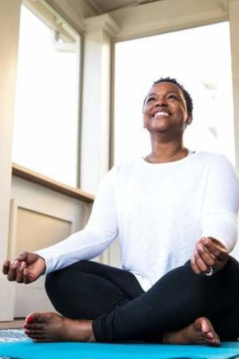 a person sitting on a yoga mat