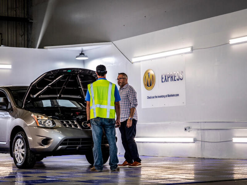 Cox Manheim employees working on car