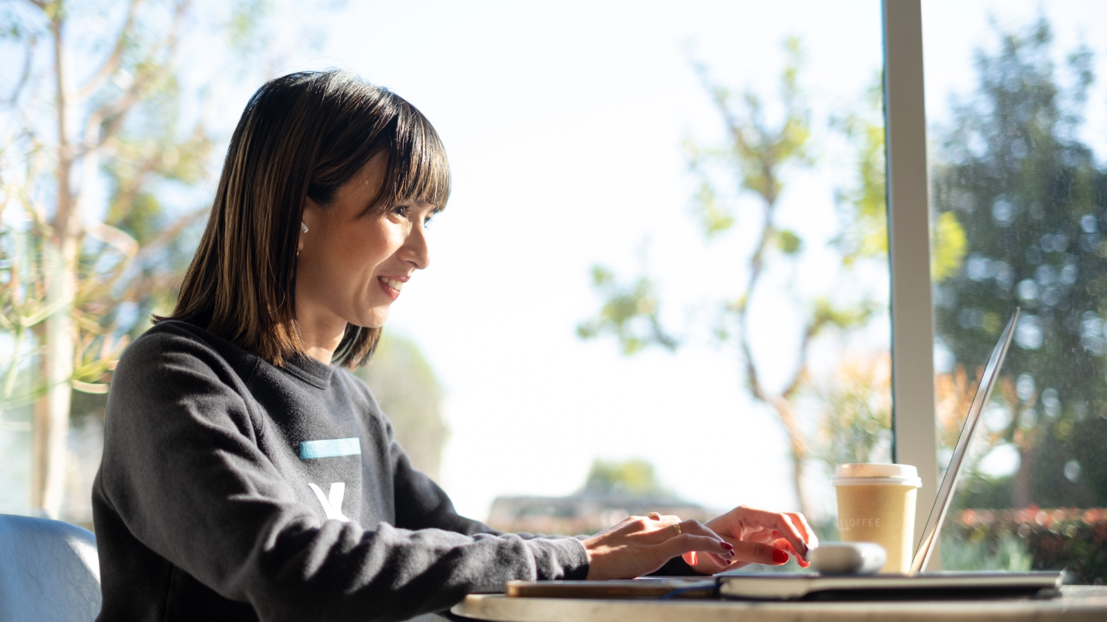 a person sitting at a table with a cup of coffee