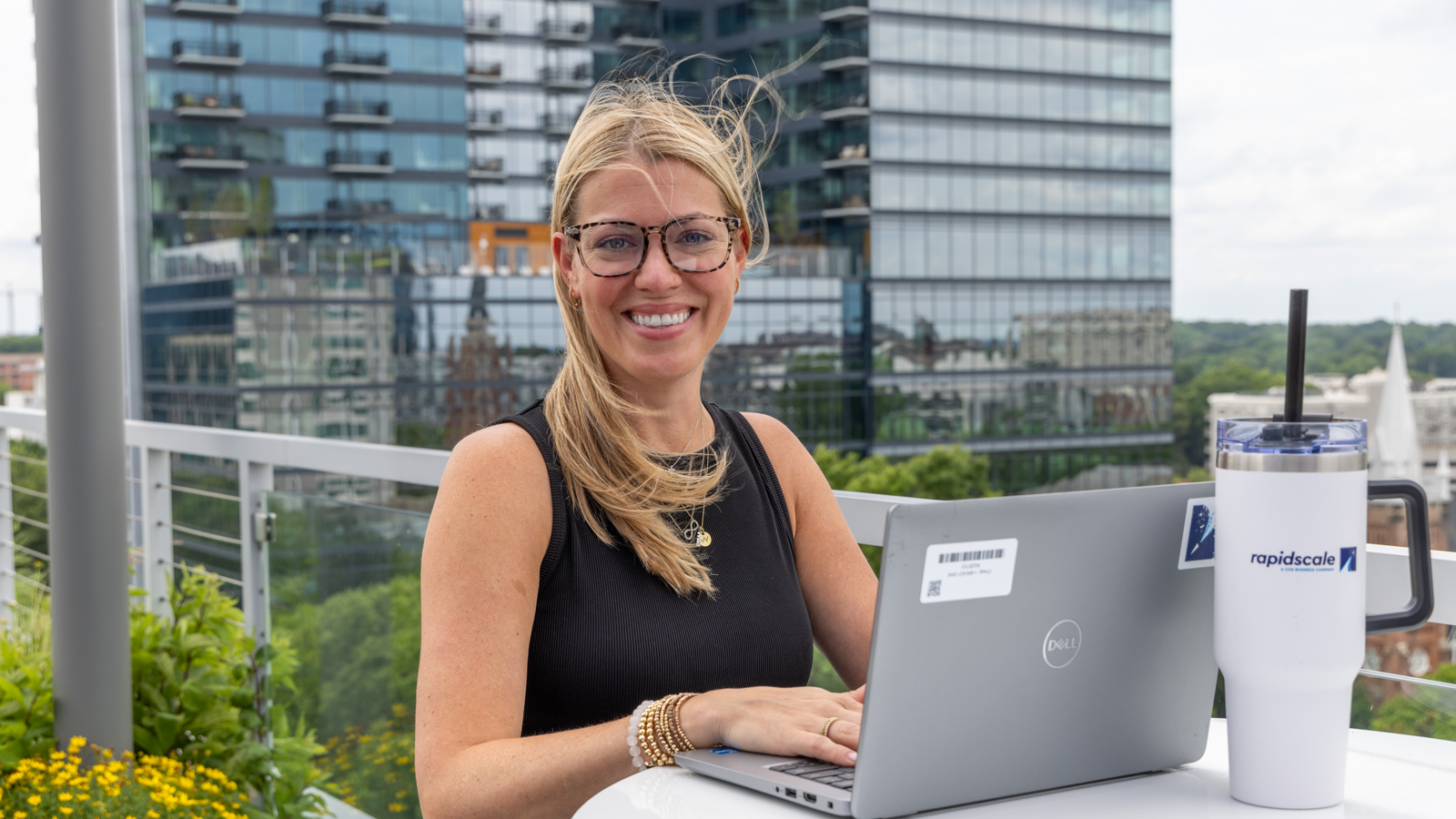 a person sitting at a table with a laptop