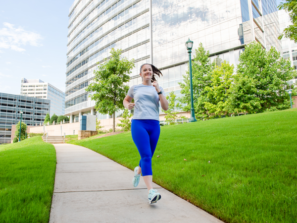 Cox employee running outdoors on campus