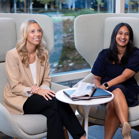 two Cox employees sitting in chairs