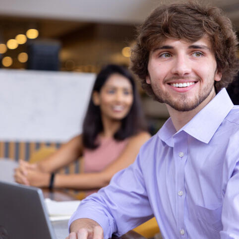 a Cox employee smiling at camera