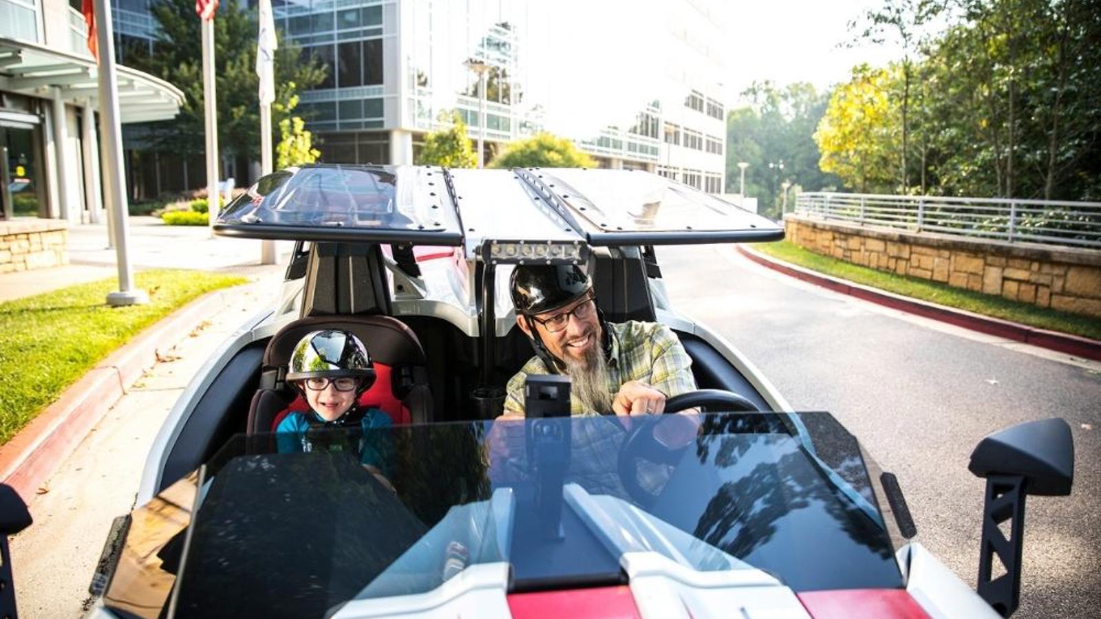 Cox employee racing a car with his son