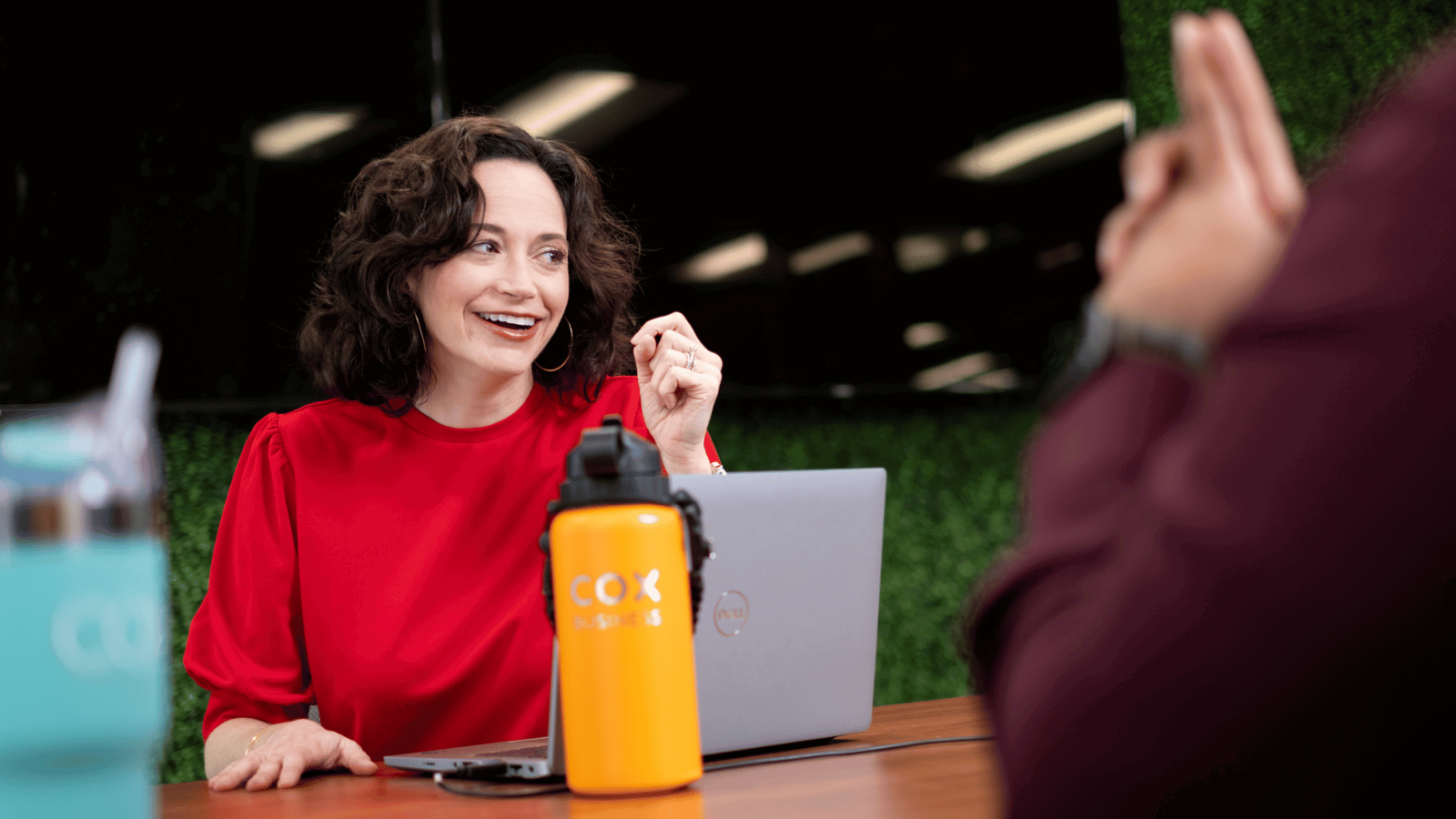 Cox employee working on laptop with a yellow water bottle