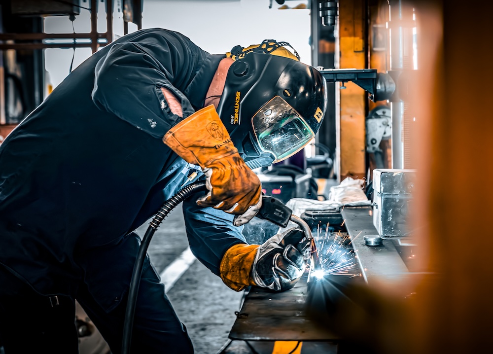 a person wearing a helmet welding metal