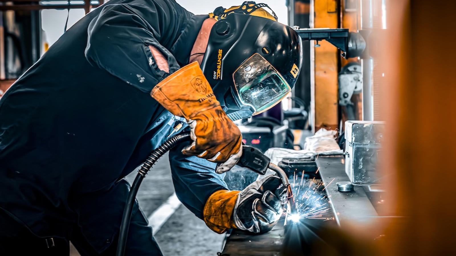a person wearing a helmet welding metal