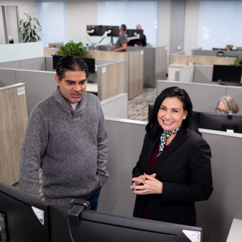 Cox employees looking at a computer