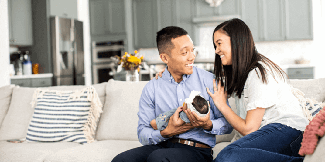 Cox employee smiling on couch with family
