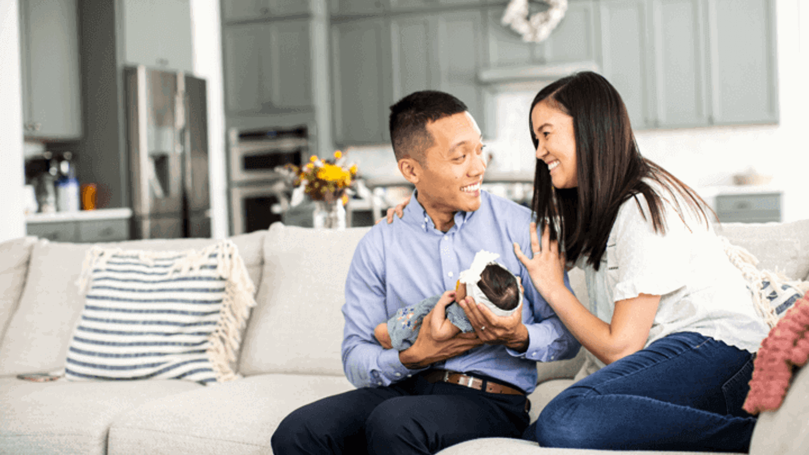 Cox employee smiling on couch with family