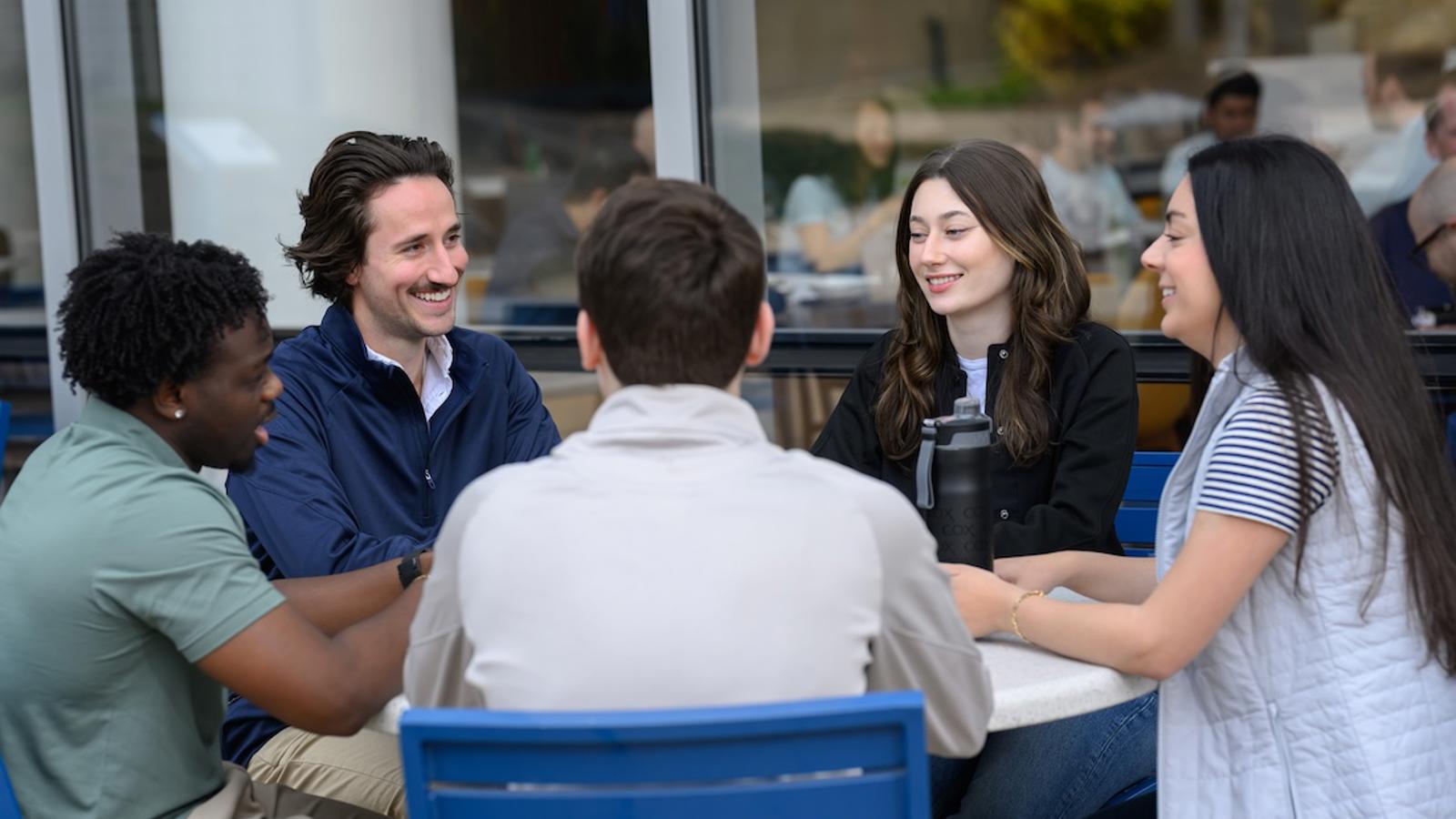a group of people sitting at a table