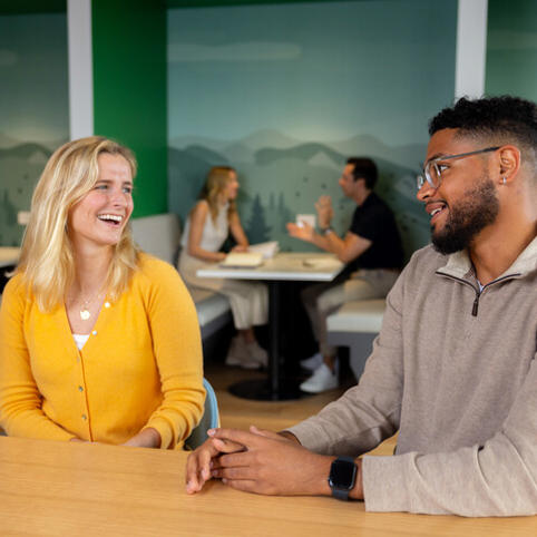two Cox employees sitting at a table
