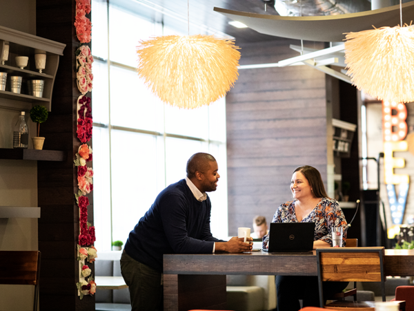 Cox employees working at a coffee shop