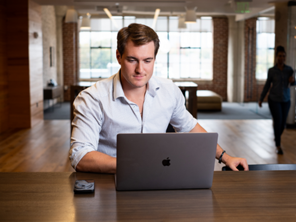 Cox employee working on computer