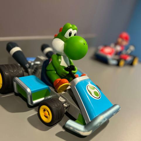 Toy yoshi driving a car