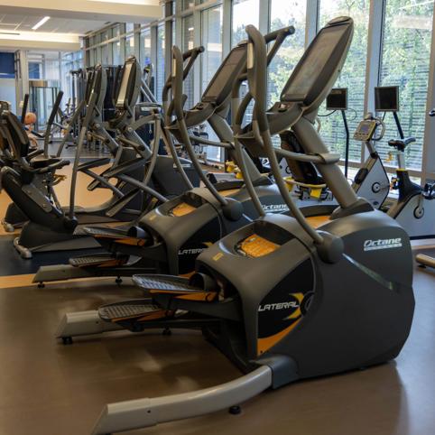 a group of exercise machines in a gym