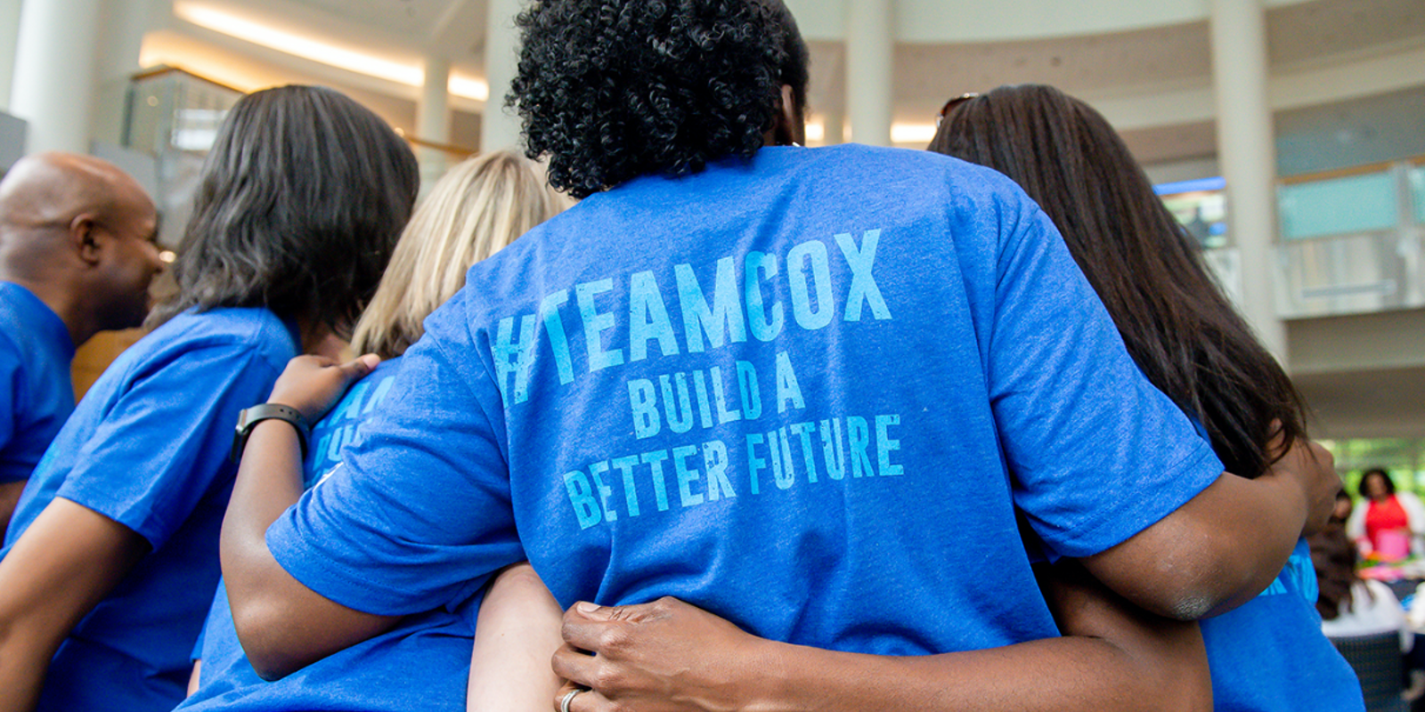 Cox employees in volunteer shirts