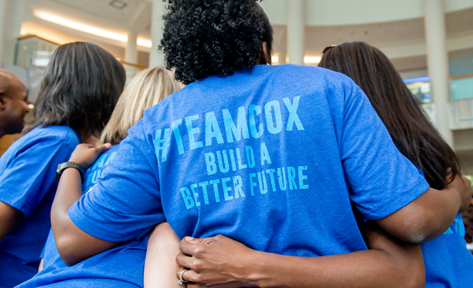 Cox employees in volunteer shirts