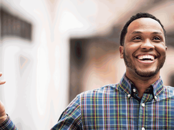 Cox employee smiling with hands in the air