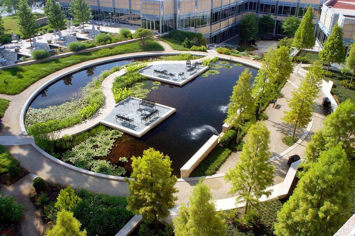 a pond with a fountain in the middle of a building