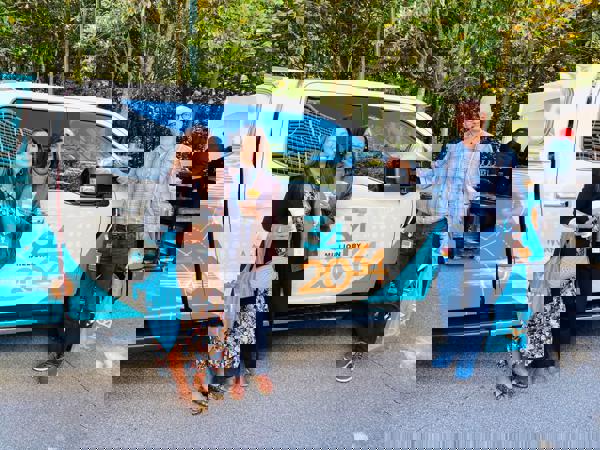 Cox employees in front of 34x34 truck