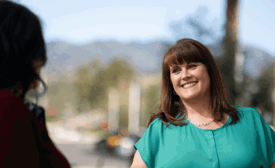 a Cox employee smiling at another person