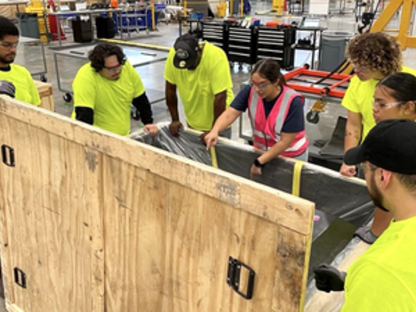 Cox employees working in a warehouse