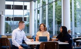 a group of Cox employees sitting at a table