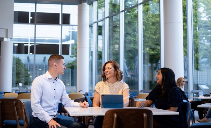 a group of Cox employees sitting at a table